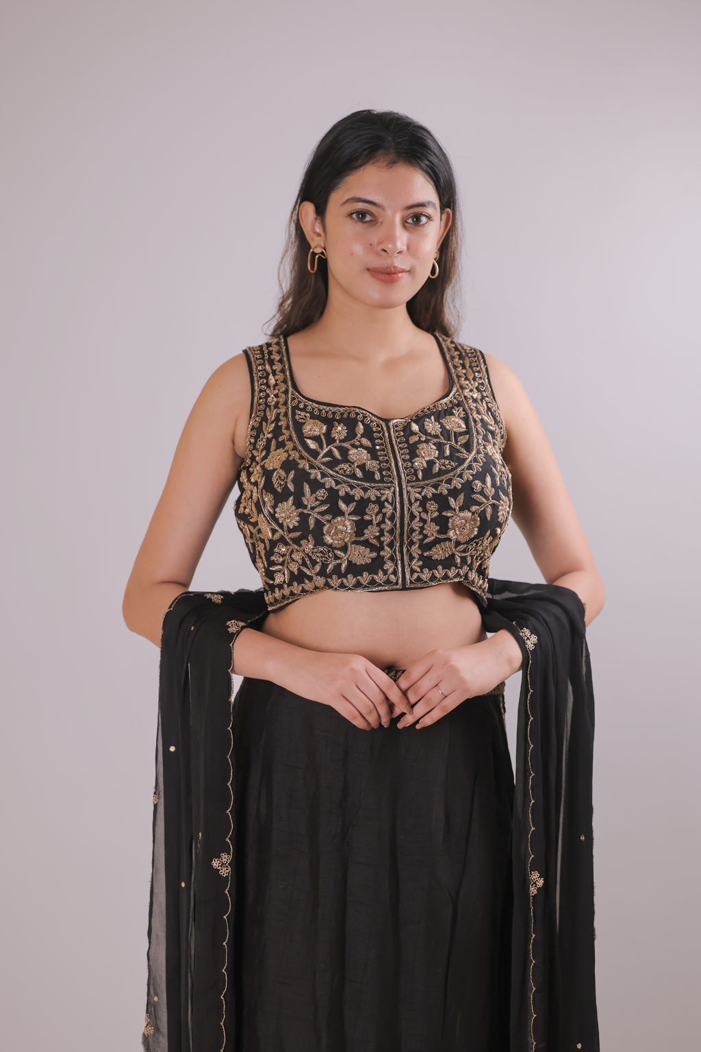 Black sleeveless top with straight skirt